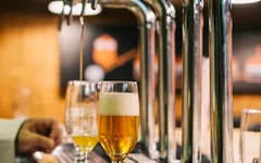 A pint being poured at the bar